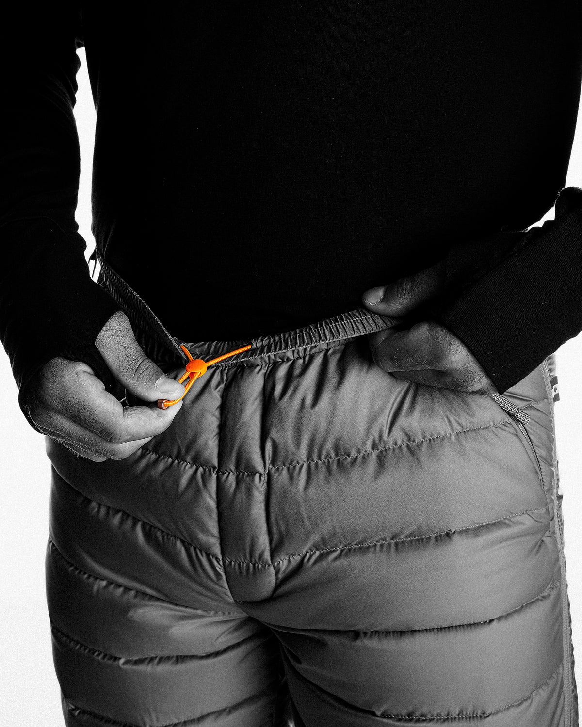 Adjustable waistband with an integrated drawcord
